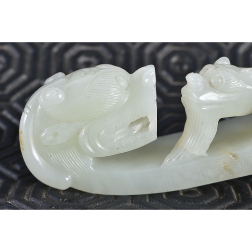 1054 - AN 18TH CENTURY CHINESE CARVED GREENISH WHITE JADE BELT HOOK Qing. 12 cm long.