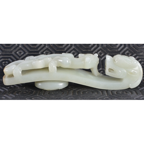 1054 - AN 18TH CENTURY CHINESE CARVED GREENISH WHITE JADE BELT HOOK Qing. 12 cm long.