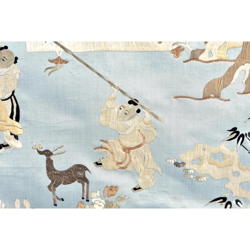 1086 - A 19TH CENTURY CHINESE SILK EMBROIDERED BLUE PANEL Qing, decorated with figures within a landscape. ... 