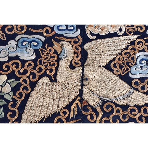 1087 - A FINE PAIR OF CHINESE QING DYNASTY SILK EMBROIDERED RANK BADGES decorated with birds in flight. 60 ... 