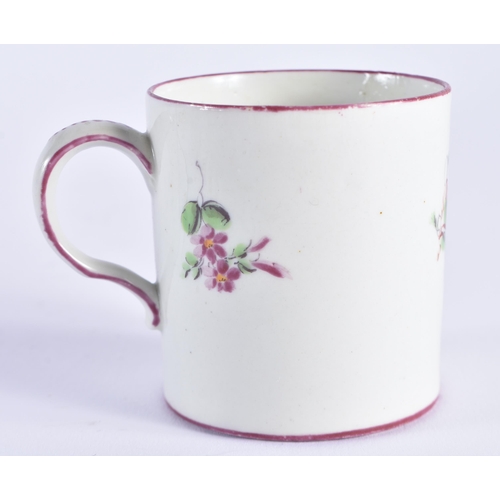 1152 - 18th century Mennecy coffee can painted with flowers under a puce border. 6 cm high.