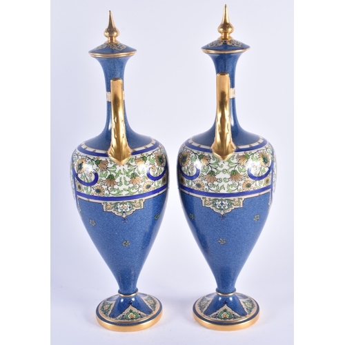 1153 - A PAIR OF ROYAL WORCESTER TWIN HANDLED PORCELAIN VASES AND COVERS painted in relief with Islamic sty... 