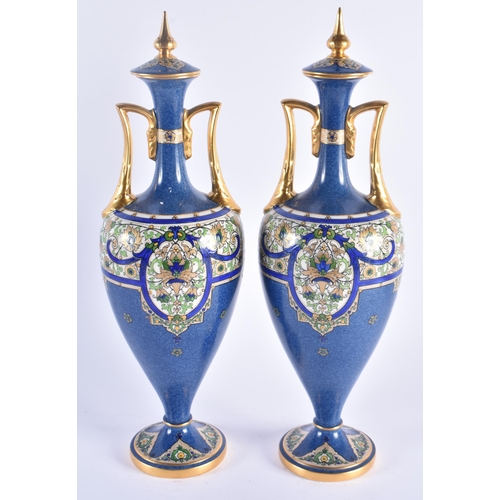 1153 - A PAIR OF ROYAL WORCESTER TWIN HANDLED PORCELAIN VASES AND COVERS painted in relief with Islamic sty... 