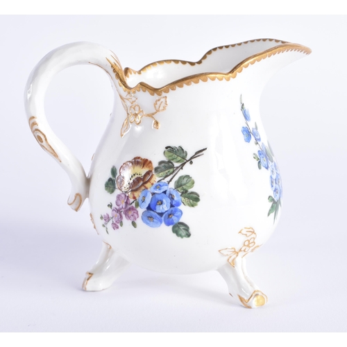 1156 - Late 18th century Sevres three footed cream jug painted with flowers, no mark. 10 cm high.