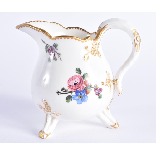 1156 - Late 18th century Sevres three footed cream jug painted with flowers, no mark. 10 cm high.