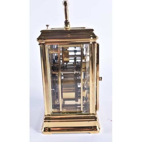 1166 - AN ANTIQUE FRENCH TRIPLE DIAL REPEATING BRASS CARRIAGE CLOCK. 18 cm high inc handle.