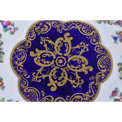 1168 - Late 18th century Sevres plate, the border painted in cobalt blue with four oval panels of flowers, ... 