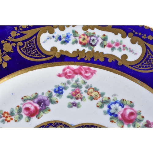 1168 - Late 18th century Sevres plate, the border painted in cobalt blue with four oval panels of flowers, ... 