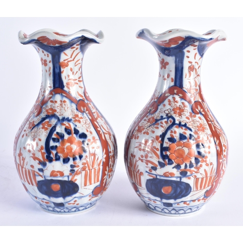 1216 - A PAIR OF 19TH CENTURY JAPANESE MEIJI PERIOD IMARI PORCELAIN VASES painted with flowers. 22 cm high.