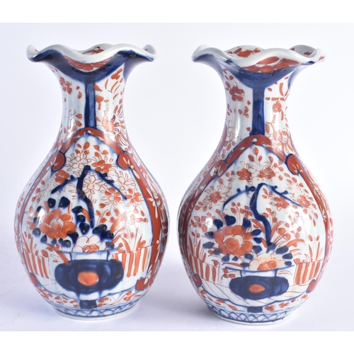 1216 - A PAIR OF 19TH CENTURY JAPANESE MEIJI PERIOD IMARI PORCELAIN VASES painted with flowers. 22 cm high.