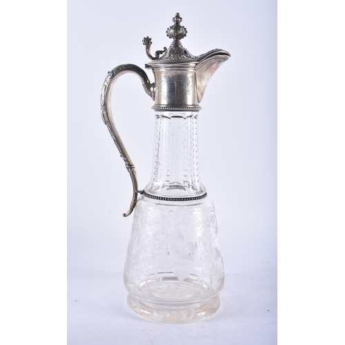 1245 - A LARGE ANTIQUE CONTINENTAL SILVER AND ENGRAVED GLASS CLARET JUG. 33 cm high.