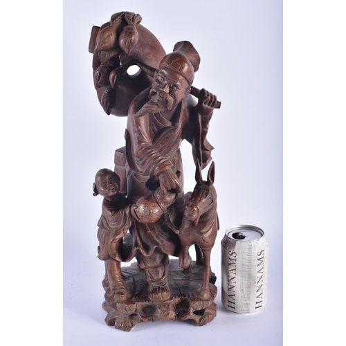 1253 - A LARGE 19TH CENTURY CHINESE CARVED HARDWOOD FIGURE modelled as a male beside a donkey. 42 cm x 15 c... 