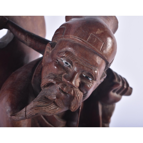 1253 - A LARGE 19TH CENTURY CHINESE CARVED HARDWOOD FIGURE modelled as a male beside a donkey. 42 cm x 15 c... 