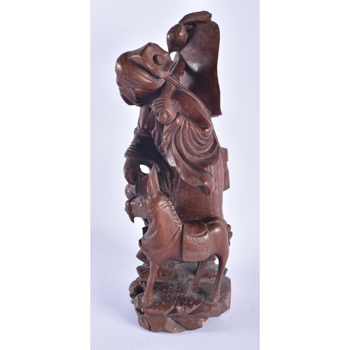 1253 - A LARGE 19TH CENTURY CHINESE CARVED HARDWOOD FIGURE modelled as a male beside a donkey. 42 cm x 15 c... 