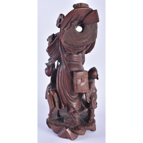 1253 - A LARGE 19TH CENTURY CHINESE CARVED HARDWOOD FIGURE modelled as a male beside a donkey. 42 cm x 15 c... 