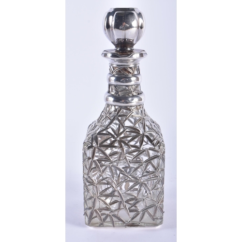 1258 - AN ANTIQUE CHINESE EXPORT SILVER MOUNTED DECANTER AND STOPPER. 26.5 cm high.