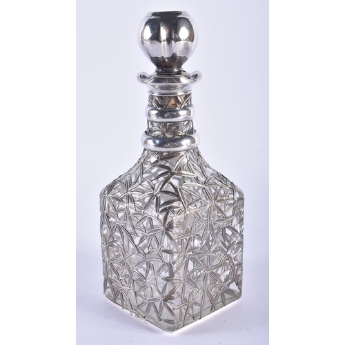 1258 - AN ANTIQUE CHINESE EXPORT SILVER MOUNTED DECANTER AND STOPPER. 26.5 cm high.