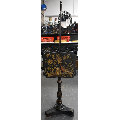 1310 - A VICTORIAN COUNTRY HOUSE BLACK LACQUERED SLIDING FIRE SCREEN decorated with raised birds within lan... 