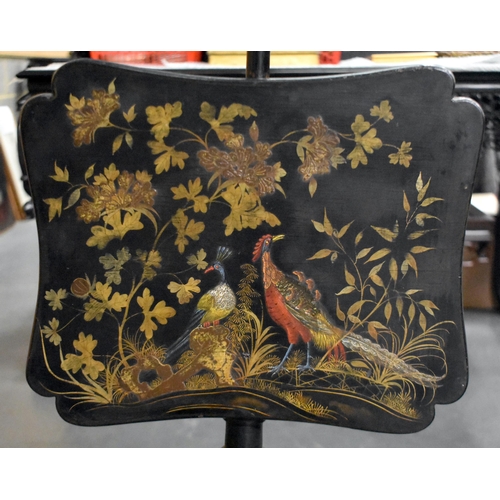 1310 - A VICTORIAN COUNTRY HOUSE BLACK LACQUERED SLIDING FIRE SCREEN decorated with raised birds within lan... 