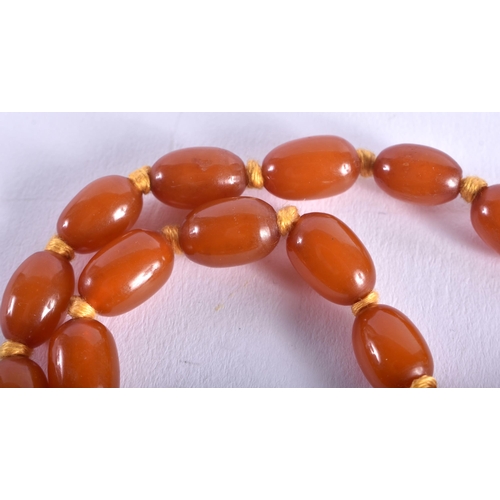 1315 - AN ART DECO SILVER MOUNTED AMBER TYPE NECKLACE. 31 grams. Each stand 46 cm long, largest bead 1.75 c... 