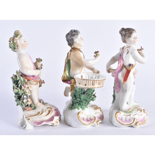 1355 - A SET OF THREE 19TH CENTURY CONTINENTAL PORCELAIN ENCRUSTED FIGURES modelled upon pink and gilt scro... 