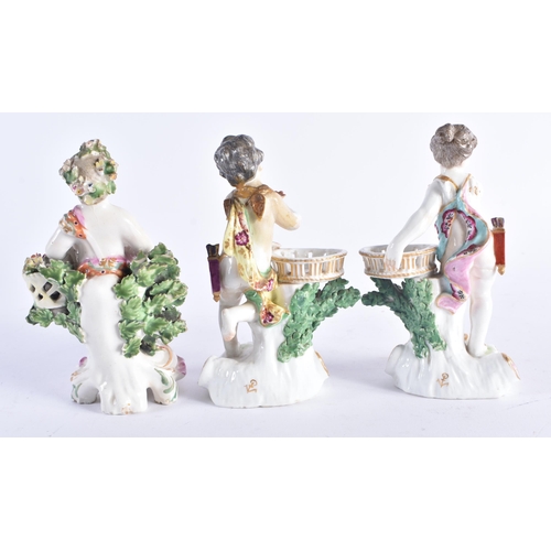 1355 - A SET OF THREE 19TH CENTURY CONTINENTAL PORCELAIN ENCRUSTED FIGURES modelled upon pink and gilt scro... 