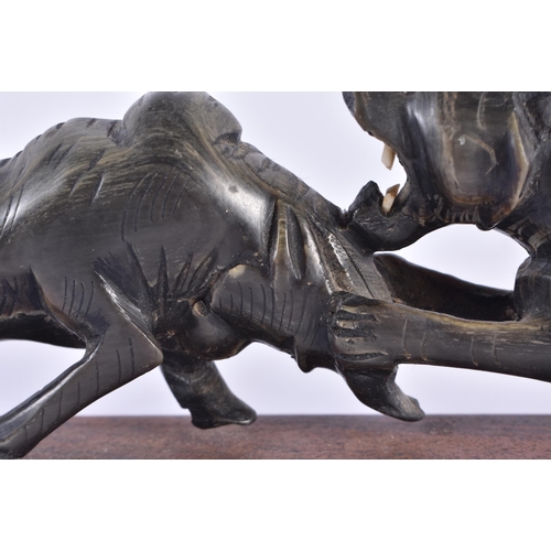 1371 - A 19TH CENTURY ANGLO INDIAN CARVED RHINOCEROS HORN FIGURE OF A LION modelled attacking a buffalo. 33... 