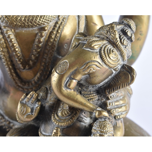 1395 - A 19TH CENTURY INDIAN BRONZE FIGURE OF A HINDU DEITY modelled holding a version of baby ganesha. 28 ... 