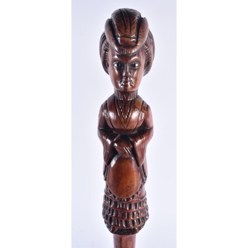 1399 - AN EARLY 19TH CENTURY CARVED FRUITWOOD FIGURAL SWAGGER STICK formed as a female. 50 cm long.