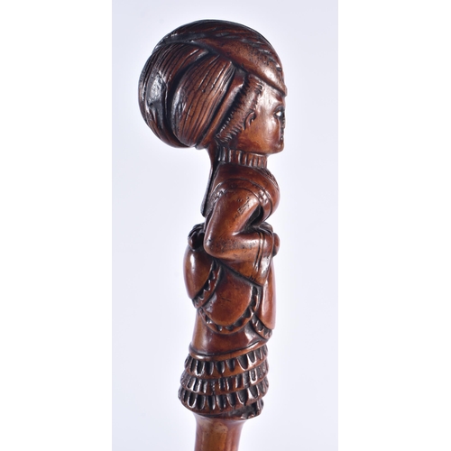 1399 - AN EARLY 19TH CENTURY CARVED FRUITWOOD FIGURAL SWAGGER STICK formed as a female. 50 cm long.