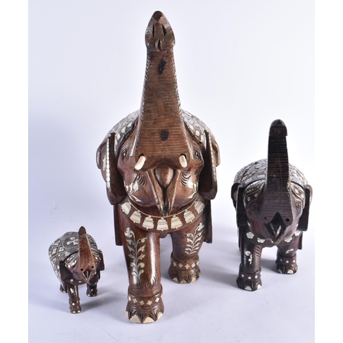 1421 - THREE ANTIQUE ANGLO INDIAN CARVED HARDWOOD BONE INLAID ELEPHANTS. Largest 46 cm x 30 cm. (3)