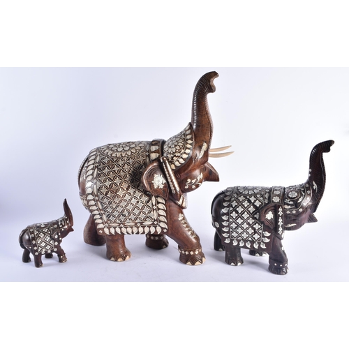 1421 - THREE ANTIQUE ANGLO INDIAN CARVED HARDWOOD BONE INLAID ELEPHANTS. Largest 46 cm x 30 cm. (3)