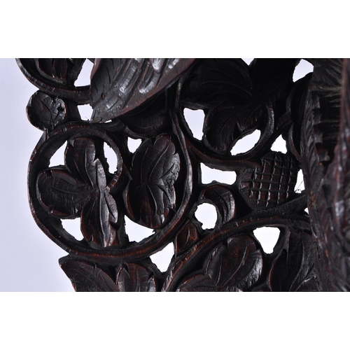 1438 - AN UNUSUAL 19TH CENTURY ANGLO INDIAN CARVED HARDWOOD HANGING PEDESTAL STAND formed with a bird with ... 