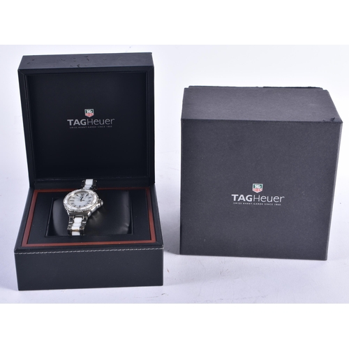 1442 - A FULL SET TAG HEUER WRISTWATCH. 3.25 cm wide inc winder.