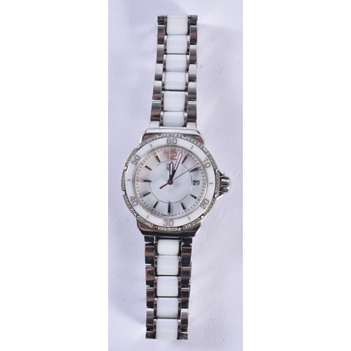 1442 - A FULL SET TAG HEUER WRISTWATCH. 3.25 cm wide inc winder.