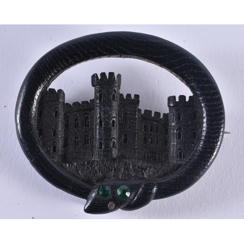 1443 - A LOVELY VICTORIAN IRISH BOG OAK CASTLE AND SERPENT BROOCH inscribed to the back Aug 1853. 6.5 cm x ... 