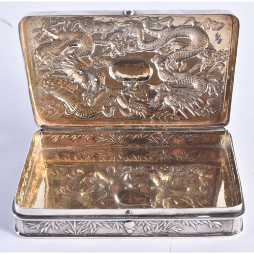 1446 - A 19TH CENTURY CHINESE EXPORT SILVER DRAGON BOX stamped WHL, depicting dragons in relief amongst clo... 