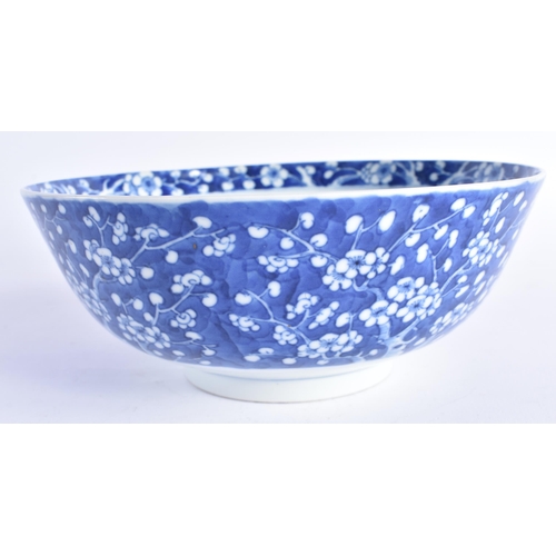 1451 - A 19TH CENTURY CHINESE BLUE AND WHITE PORCELAIN BOWL Qing, painted with prunus and flowers. 20 cm di... 