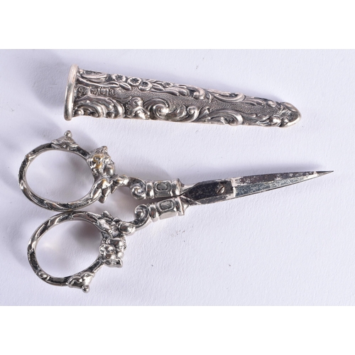 1459 - A PAIR OF ANTIQUE SILVER CASED SCISSORS together with other silver sewing tools. 52 grams overall. (... 