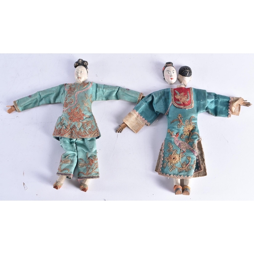 1493 - A PAIR OF LATE 19TH CENTURY SILK EMBROIDERED PUPPETS with pottery heads. 25 cm long.