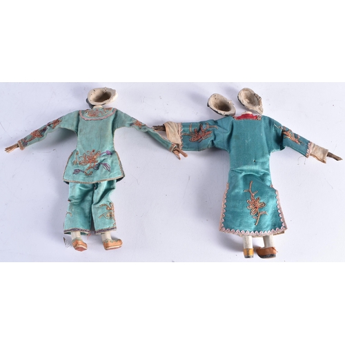 1493 - A PAIR OF LATE 19TH CENTURY SILK EMBROIDERED PUPPETS with pottery heads. 25 cm long.