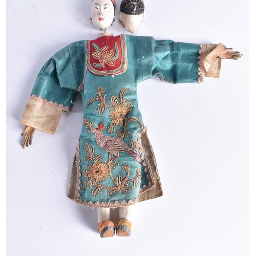 1493 - A PAIR OF LATE 19TH CENTURY SILK EMBROIDERED PUPPETS with pottery heads. 25 cm long.