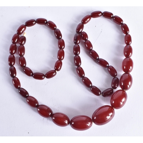 1507 - A CHERRY AMBER TYPE NECKLACE. 47.1 grams. 72 cm long, largest bead 2 cm x 1.5 cm.