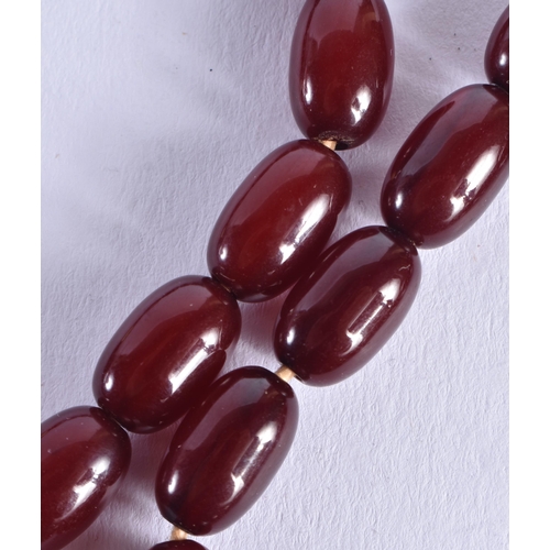 1507 - A CHERRY AMBER TYPE NECKLACE. 47.1 grams. 72 cm long, largest bead 2 cm x 1.5 cm.