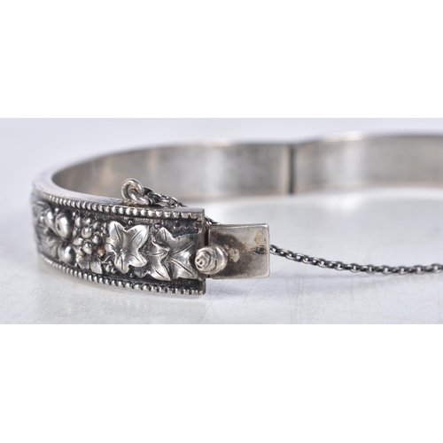 768 - Collection of Silver Bangles Inc. Floral, Safety Chain x 2 53g. 6.25 cm x 5.5 cm. (2)