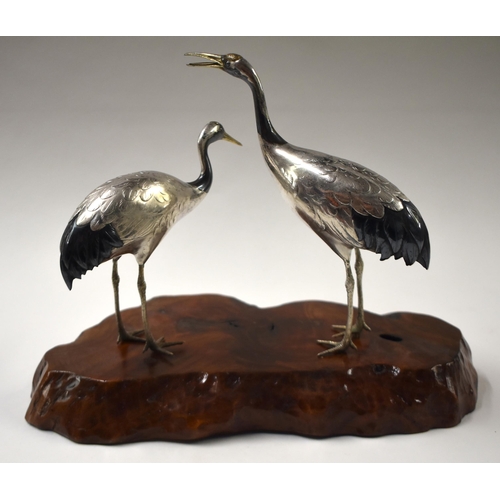 811 - A 19TH CENTURY JAPANESE MEIJI PERIOD SILVER MIXED METAL AND SHAKUDO OKIMONO modelled as cranes. 24 c... 