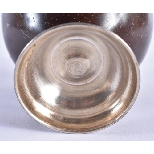 982 - AN ANTIQUE SILVER MOUNTED COCONUT CUP. 9 cm x 8 cm.