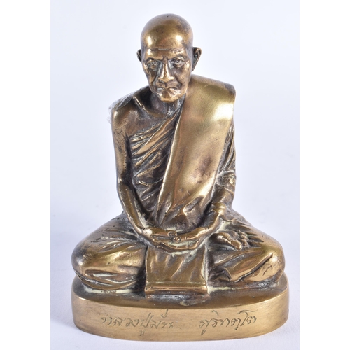 983 - AN EARLY 20TH CENTURY SOUTH EAST ASIAN BRONZE BUDDHA modelled seated, the base engraved with scriptu... 