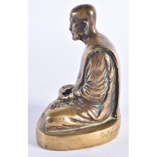 983 - AN EARLY 20TH CENTURY SOUTH EAST ASIAN BRONZE BUDDHA modelled seated, the base engraved with scriptu... 