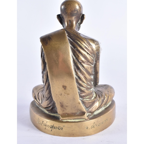 983 - AN EARLY 20TH CENTURY SOUTH EAST ASIAN BRONZE BUDDHA modelled seated, the base engraved with scriptu... 